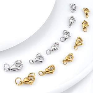 Golden and silver lobster clasps on white geometric stands for DIY jewelry making
