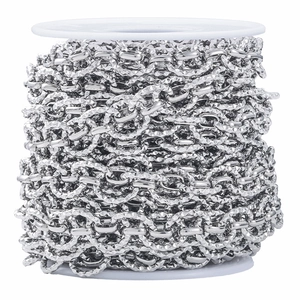 Polished silver textured oval link chain for DIY jewelry making on white spool