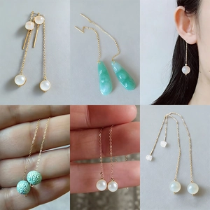 Golden stainless steel long chain earrings featuring pearls and green jade pendants