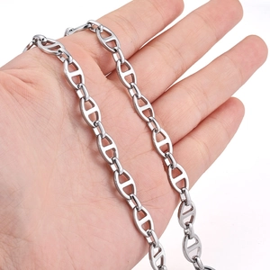 Polished silver stainless steel oval anchor chain link necklace held in hand on white background