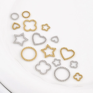 Polished gold and silver DIY jewelry connectors in heart, star, and clover bead shapes