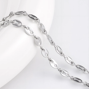 Polished stainless steel pig nose link chain for DIY jewelry making on white ceramic