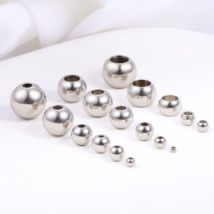Close-up of assorted sizes of polished stainless steel beads for DIY jewelry making