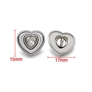 Detailed macro view of 17mm crystal heart button with silver alloy textured back