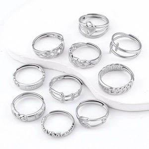Set of 10 silver stainless steel rings featuring heart lock, cross, and love designs