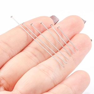 Flat head pins in six different lengths held by hand for jewelry making and DIY crafts