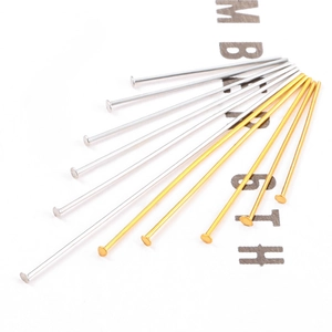 Macro shot of assorted gold and silver stainless steel T-pins and eye pins for jewelry DIY