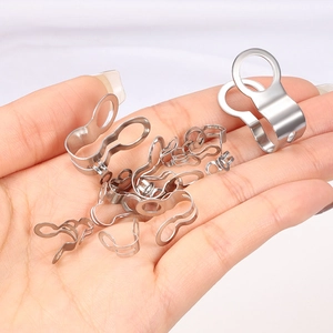 Polished stainless steel ball chain connectors held in hand showing compact size