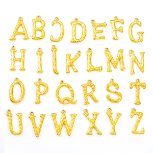 Macro shot of 26-piece alphabet pendants with 18k gold plating and bamboo texture