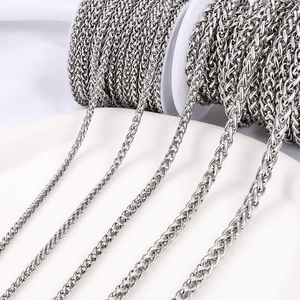 Polished silver stainless steel wheat chains in four sizes on white spool rolls