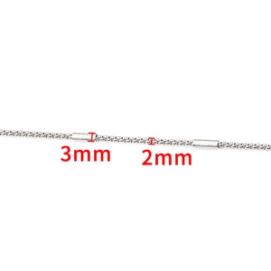 Macro detail of 2mm silver dragon bone chain with 3mm cylindrical metal bead accents