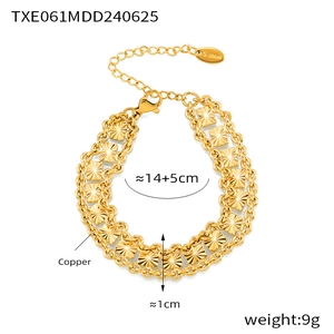 Detail of gold-plated copper double chain bracelet with square sunburst texture and tag