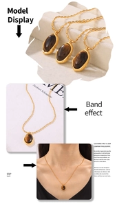 Detail of 18k gold plated necklace with oval tiger eye stone pendant and beaded chain