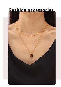 Double layer gold necklace with flat snake chain and oval tiger eye stone pendant