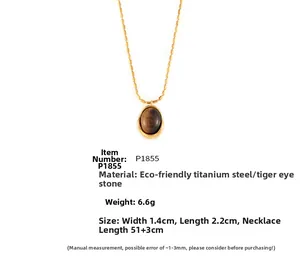 Detail view of oval tiger's eye pendant on 18k gold-plated titanium steel necklace