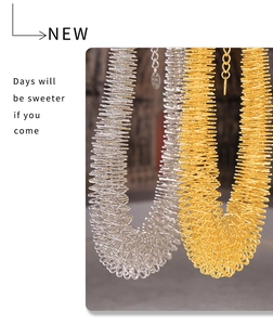 Detail of spiral spring pendant necklaces in gold and silver with industrial metallic textures
