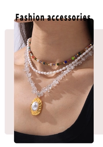 Detailed view of triple-layered gold necklace with pearls and crystal gravel stones
