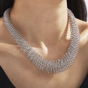 Modern silver spiral spring necklace with a bold geometric design on a male model