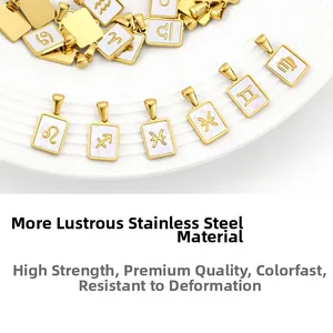 Detailed close-up of golden stainless steel zodiac pendants with white shell inlay