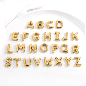 Macro detail of complete A-Z gold bubble letter pendants with 3D mirrored finish surface