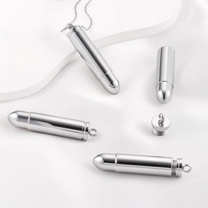 Polished stainless steel bullet pendant necklace with a screw-top design shown on silk