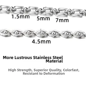 Detail of stainless steel cross and bead chains showing varied links and precise dimensions