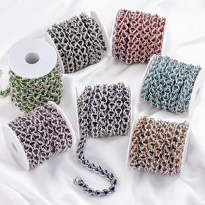 Detail of colorful beads woven into stainless steel chain links for DIY jewelry making