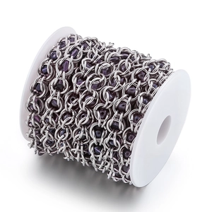 DIY stainless steel chain with purple faceted crystal beads on white plastic reel
