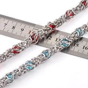 Macro shot of 8mm stainless steel Byzantine chain with red and blue beads for jewelry DIY