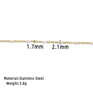 Macro detail of 1.7mm gold stainless steel chain with 2.1mm white enamel beads