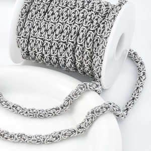 Silver Byzantine stainless steel chain on a white spool for DIY jewelry making