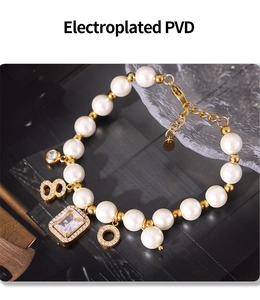 Detailed view of gold PVD plated bracelet with pearls and emerald cut crystal charms