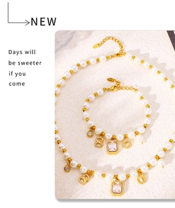 Detailed macro view of gold plated pearl necklace set with vintage geometric pendants