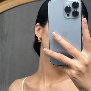 Minimalist geometric triangle gold stud earrings shown on model for a modern daily look
