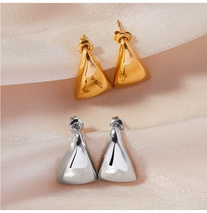 Close-up of geometric triangle titanium steel studs with detailed engraved patterns