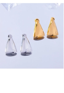 Macro shot of 3D geometric triangle studs in polished gold and silver finishes
