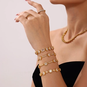 Set of four 18K gold plated stainless steel bracelets with sparkling cubic zirconia stones
