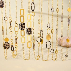 Long boho necklace collection in gold with leopard print acrylic geometric charms