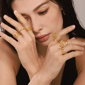 Set of irregular 18K gold plated stackable rings featuring butterfly and floral designs