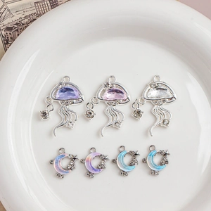Detailed view of jellyfish and moon charms with zircon inlays for DIY jewelry making