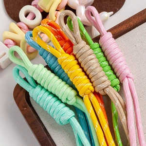 Detailed view of colorful nylon braided rope keychains in various vibrant hues