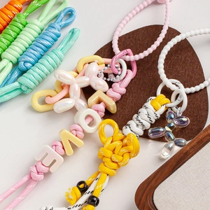 Macro detail of 5mm colorful nylon rope keychains with resin balloon dog charms