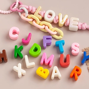 Macro detail of colorful acrylic letter beads for DIY keychain and bracelet making