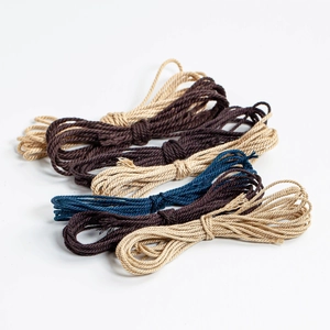 DIY handmade braided cords in coffee, beige, and navy colors with natural fiber texture