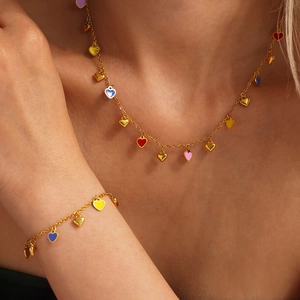Gold stainless steel jewelry set with colorful enamel heart charms on necklace and bracelet