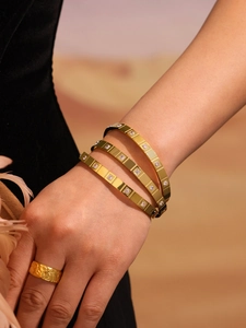 Macro shot of 18k gold plated stainless steel bangles with sparkling CZ stones inlay