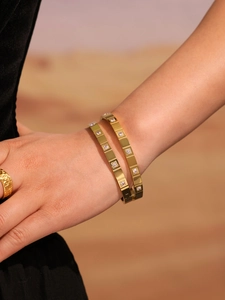 Detail of 18k gold plated stainless steel bangles with sparkling zircon inlay on wrist