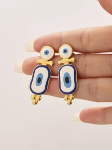 Detailed view of gold stainless steel earrings with blue enamel evil eye design details