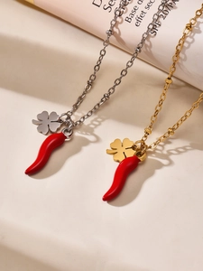 Detailed close-up of 18k gold plated red chili and clover charms on fine beaded chains