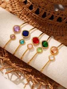 Detailed close-up of 18k gold-plated thin open bangles with colorful square Czech glass